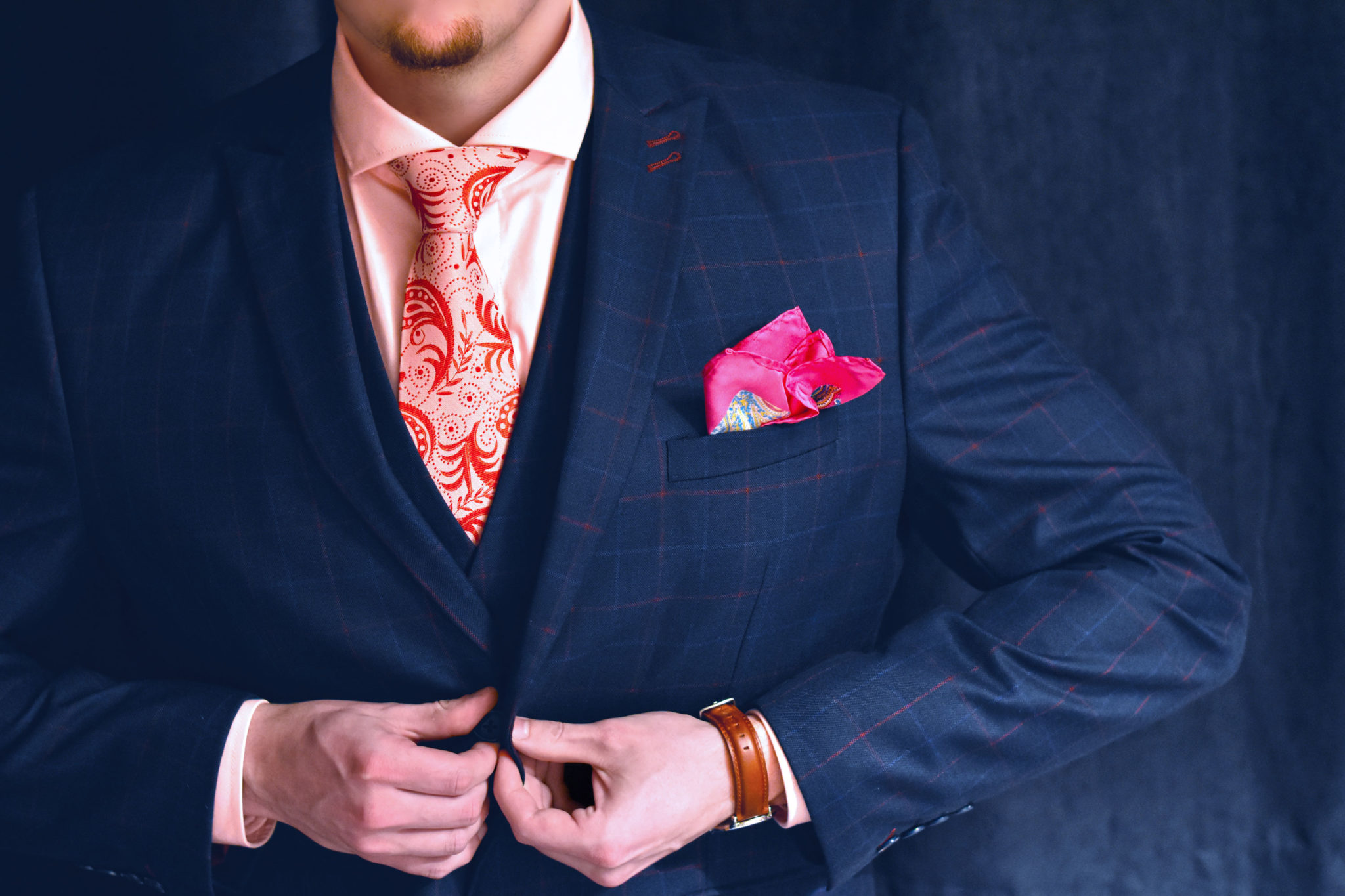 Pink tie on white background with red paisley pattern