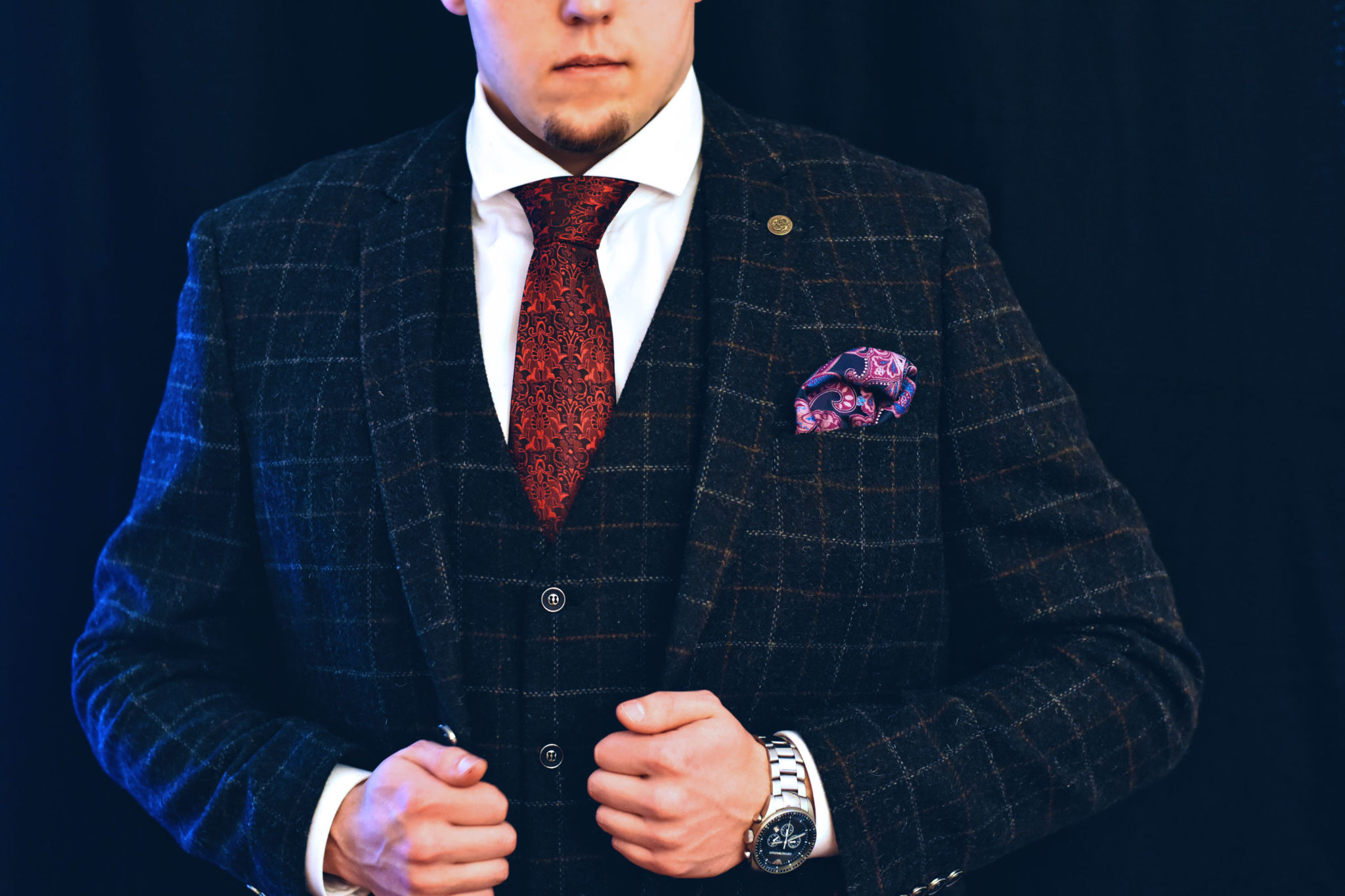 Red floral tie in black checked suit